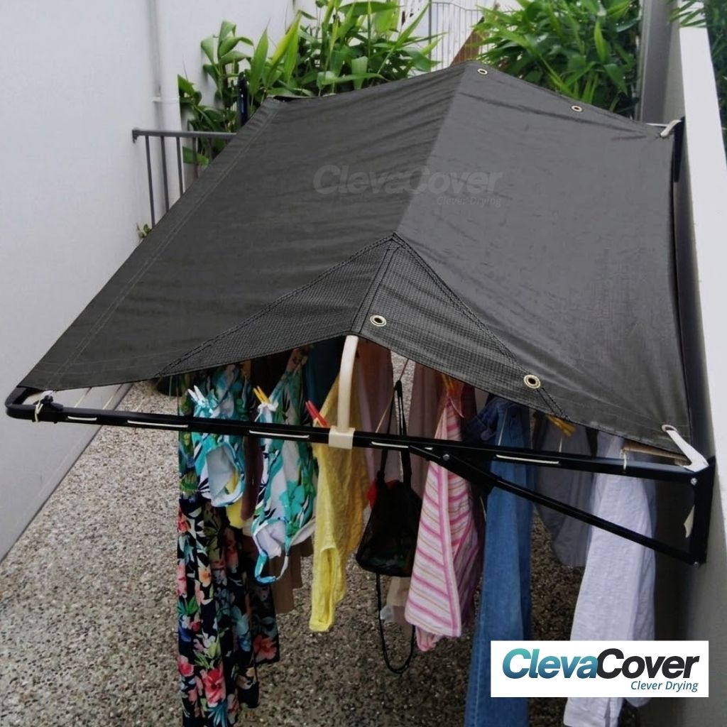 Wall Mounted Clothesline with a ClevaCover fitted, laundry hanging underneath the cover.